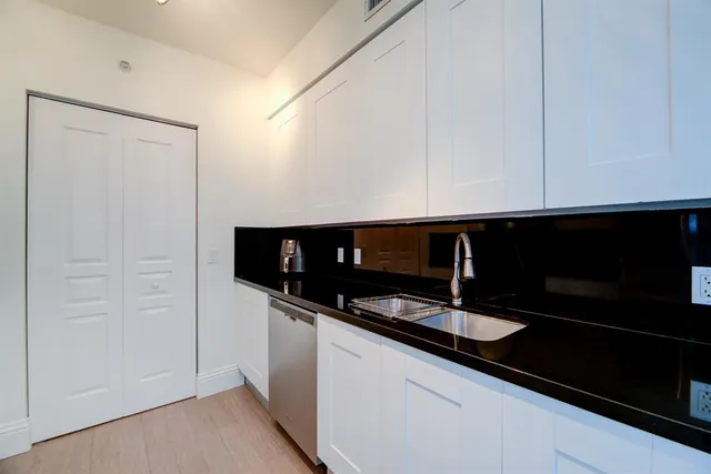 a kitchen with a sink and cabinets
