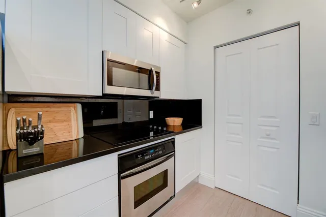 a kitchen with stainless steel appliances a stove and a microwave
