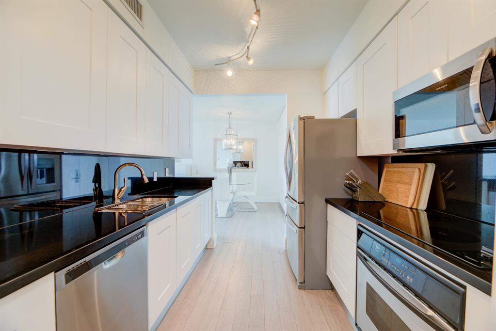 350 Southeast 2nd Street, Unit 1680 Fort Lauderdale, FL 33301 - Photo 15 of 35 a kitchen with stainless steel appliances granite countertop a refrigerator and a stove
