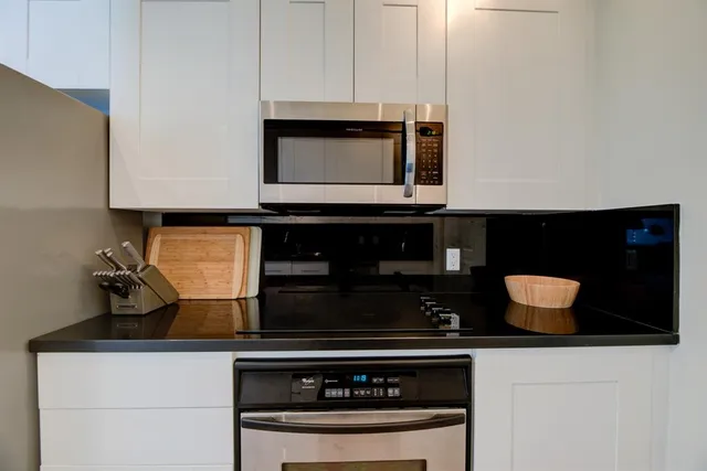 a stove top oven sitting inside of a kitchen