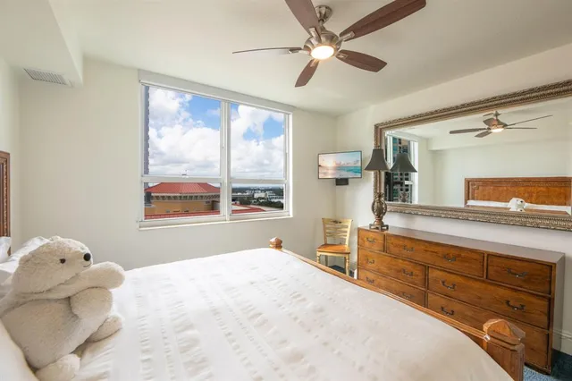 a bedroom with a large bed and a window