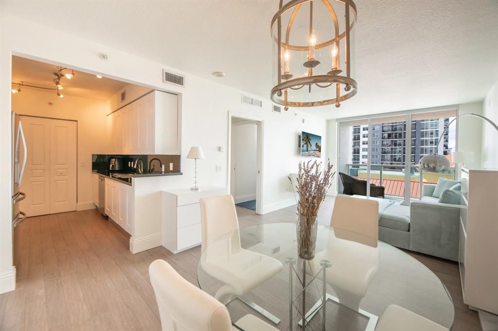 350 Southeast 2nd Street, Unit 1680 Fort Lauderdale, FL 33301 - Photo 3 of 35 a living room with furniture a couch and large mirror with wooden floor