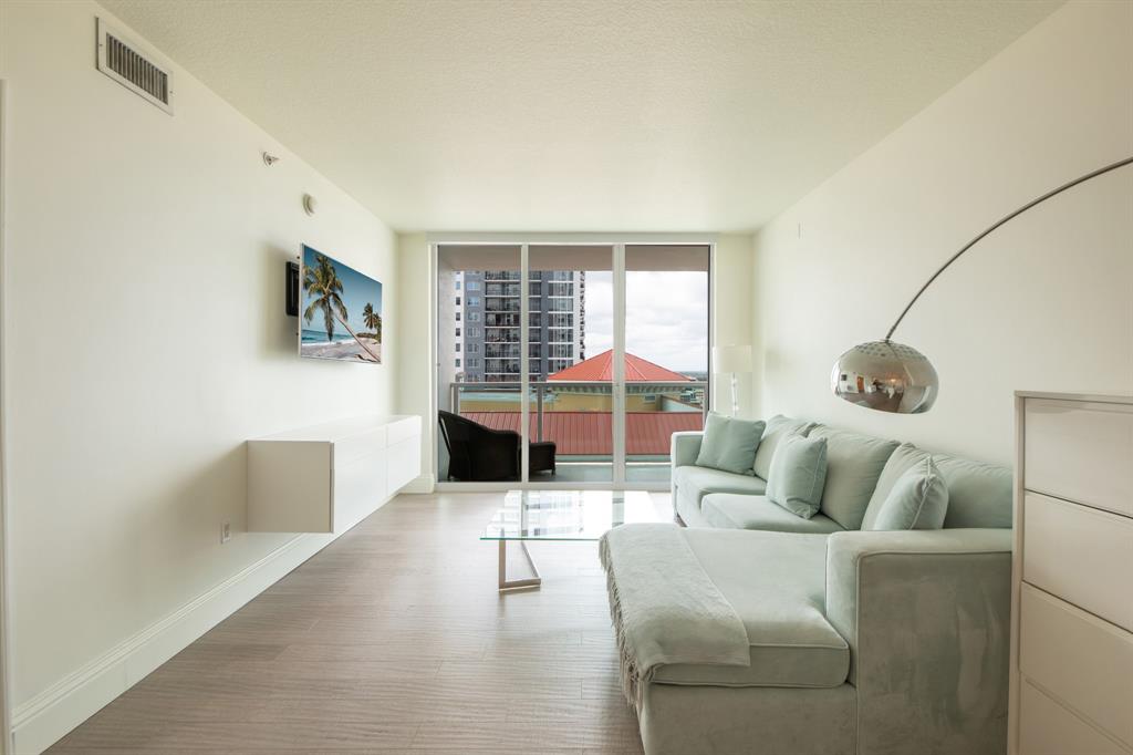 350 Southeast 2nd Street, Unit 1680 Fort Lauderdale, FL 33301 - Photo 5 of 35 a living room with furniture and a floor to ceiling window
