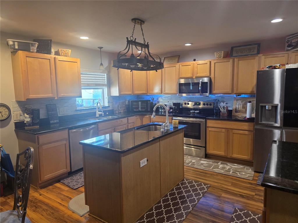 959 Thomas Road Eagle Lake, FL 33839 - Photo 17 of 35 a kitchen with stainless steel appliances granite countertop a sink stove and refrigerator