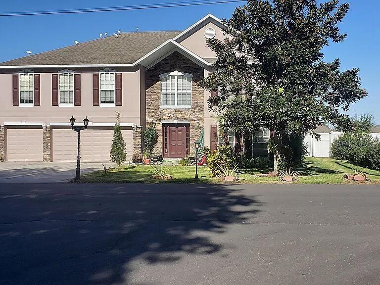 959 Thomas Road Eagle Lake, FL 33839 - Photo 2 of 35 a front view of a house with garden
