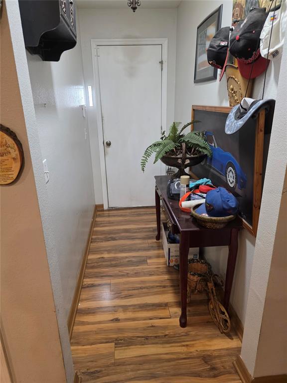959 Thomas Road Eagle Lake, FL 33839 - Photo 27 of 35 a view of a hallway with furniture and wooden floor
