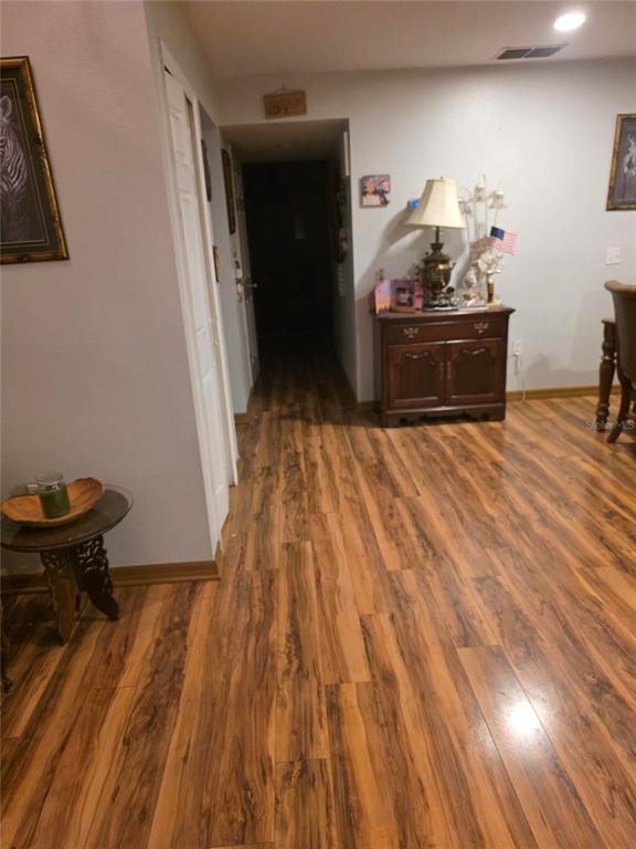 959 Thomas Road Eagle Lake, FL 33839 - Photo 30 of 35 a view of a bedroom with wooden floor and furniture