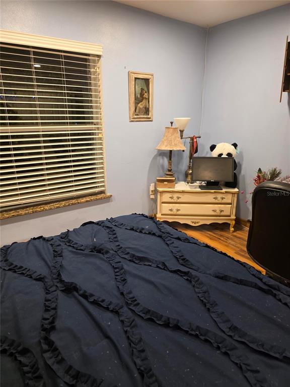 959 Thomas Road Eagle Lake, FL 33839 - Photo 32 of 35 a bed sitting in a bedroom next to a window