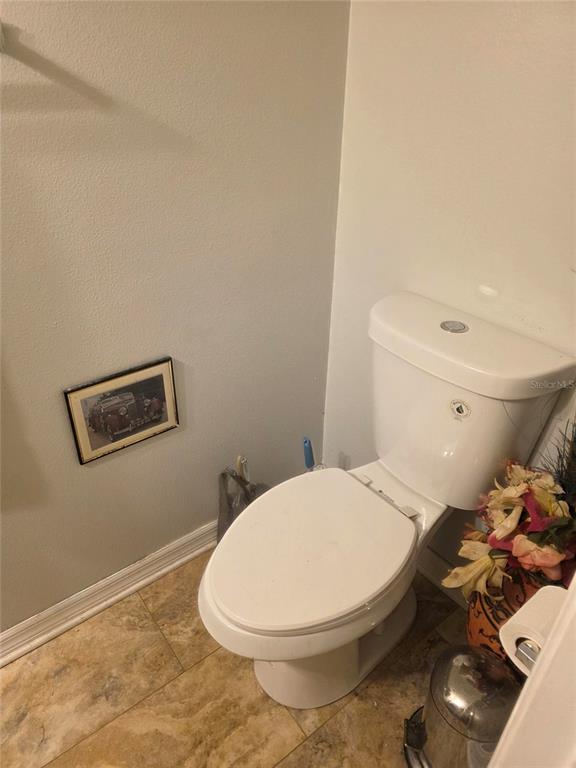959 Thomas Road Eagle Lake, FL 33839 - Photo 35 of 35 a white toilet sitting next to a bathroom sink and vanity