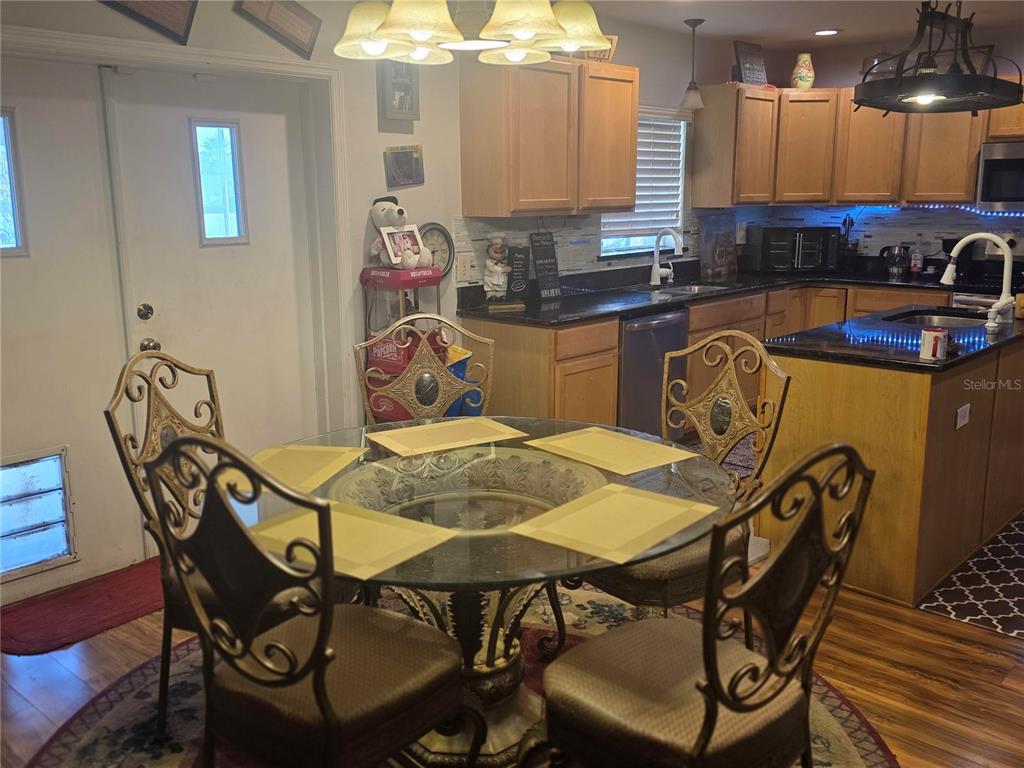 959 Thomas Road Eagle Lake, FL 33839 - Photo 8 of 35 a view of a dining room with furniture and chandelier