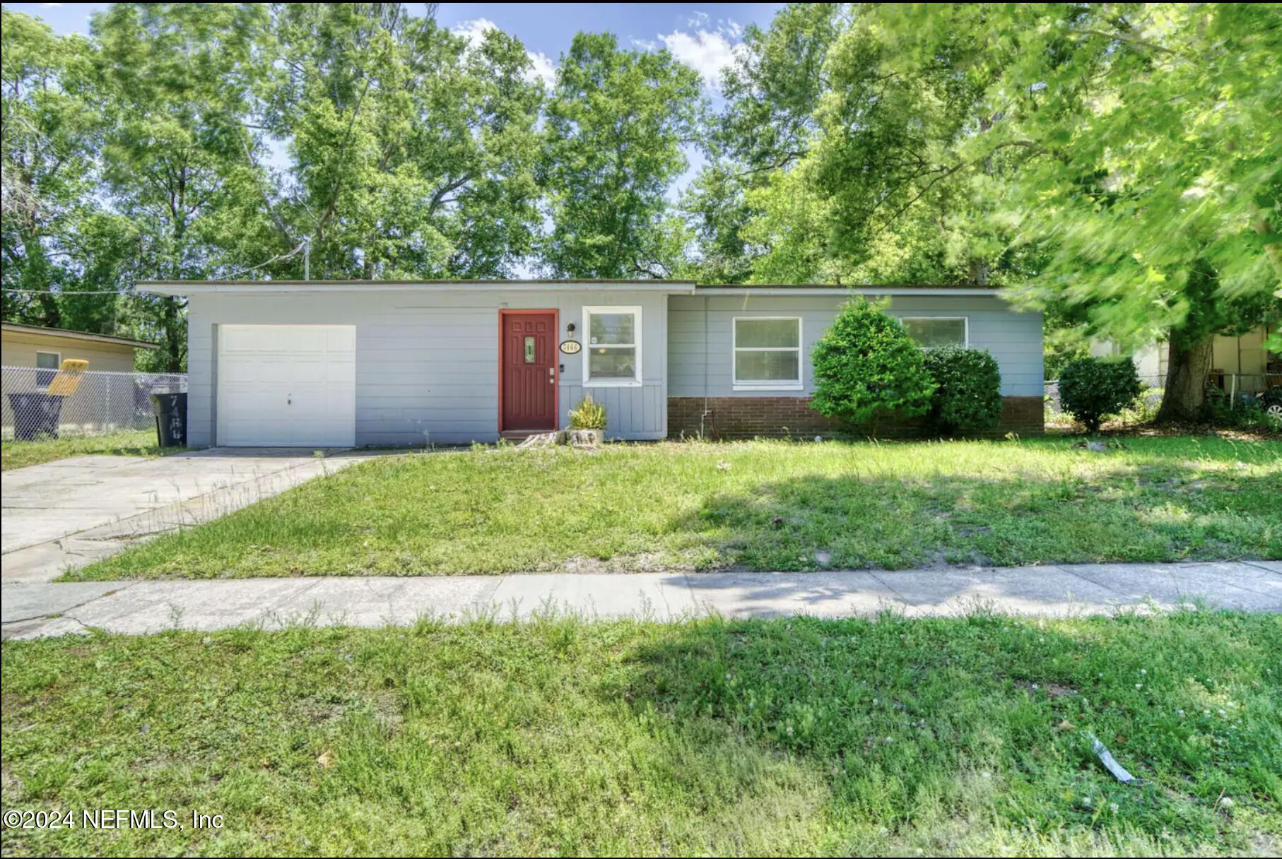 7466 Proxima Road Jacksonville, FL 32210 - Photo 1 of 34 a front view of a house with a yard and trees