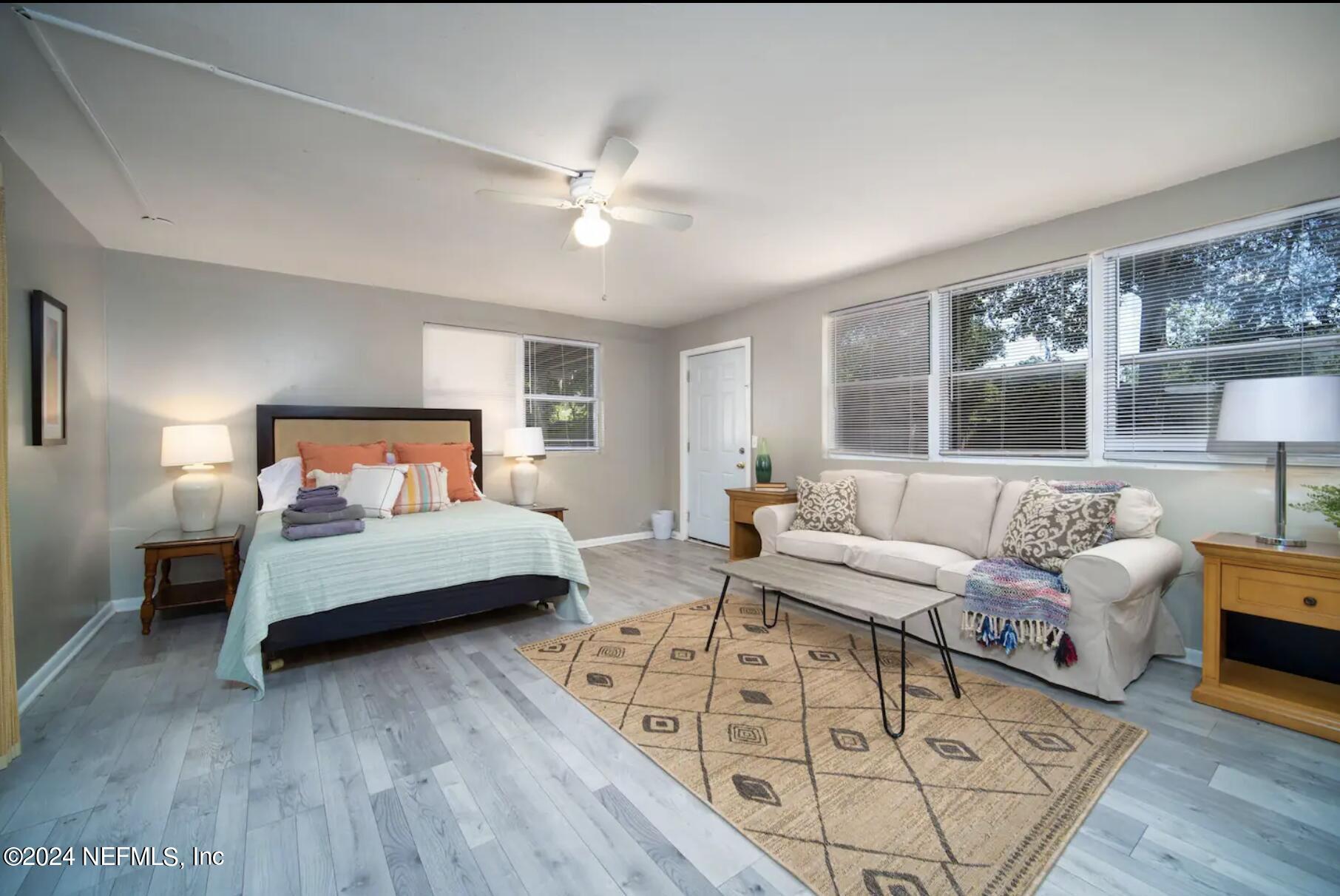 7466 Proxima Road Jacksonville, FL 32210 - Photo 17 of 34 a bedroom with furniture and wooden floor