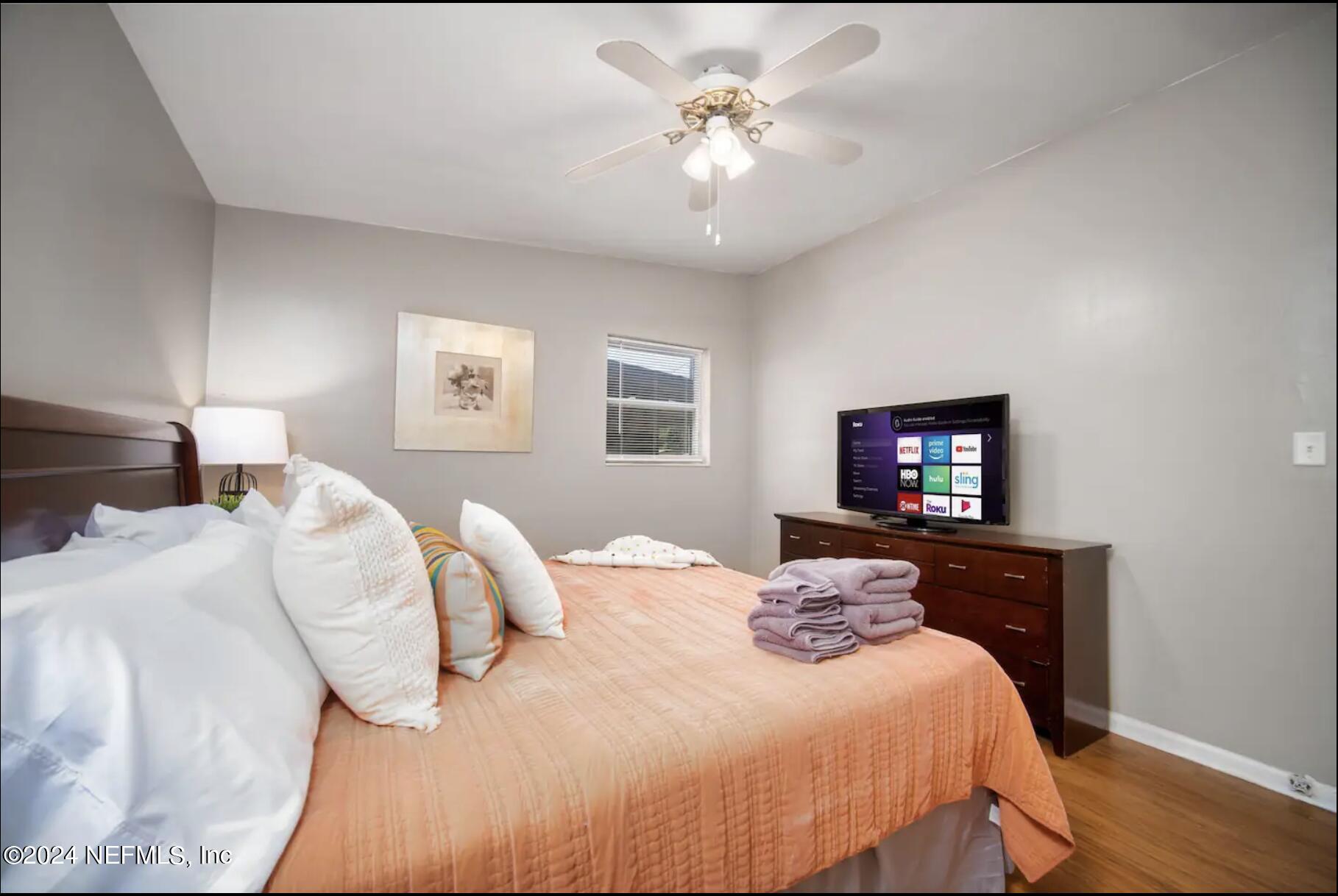 7466 Proxima Road Jacksonville, FL 32210 - Photo 19 of 34 a bedroom with a bed and a tv