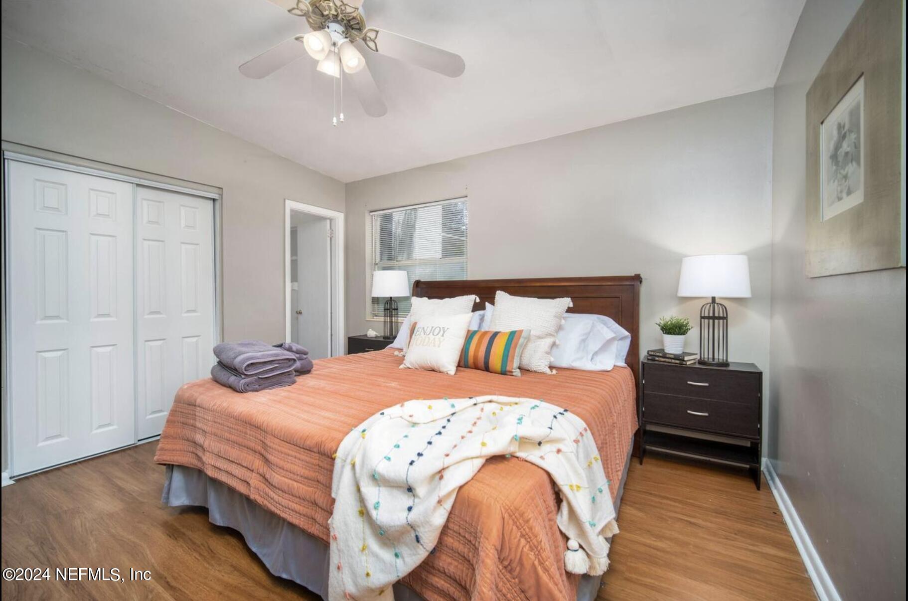 7466 Proxima Road Jacksonville, FL 32210 - Photo 20 of 34 a bedroom with a bed and a chandelier