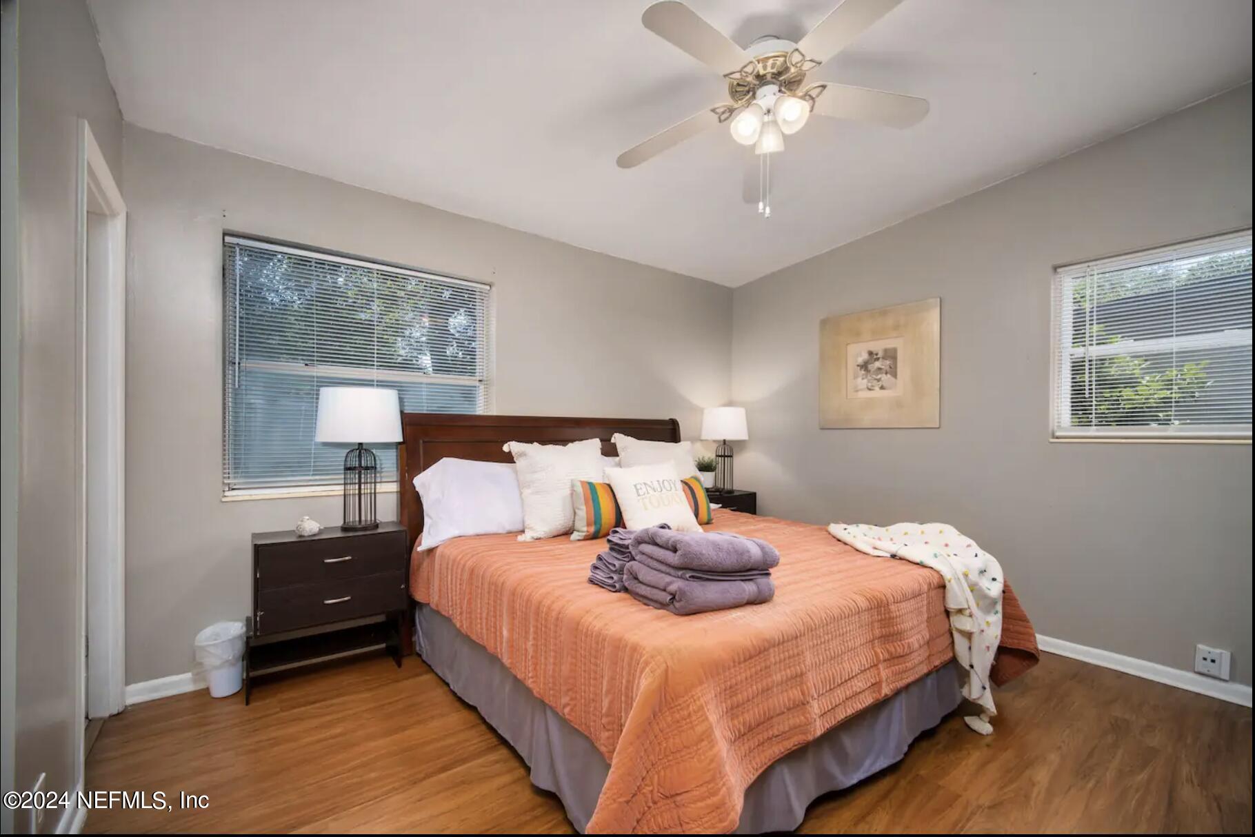 7466 Proxima Road Jacksonville, FL 32210 - Photo 21 of 34 a bedroom with a bed and a chandelier