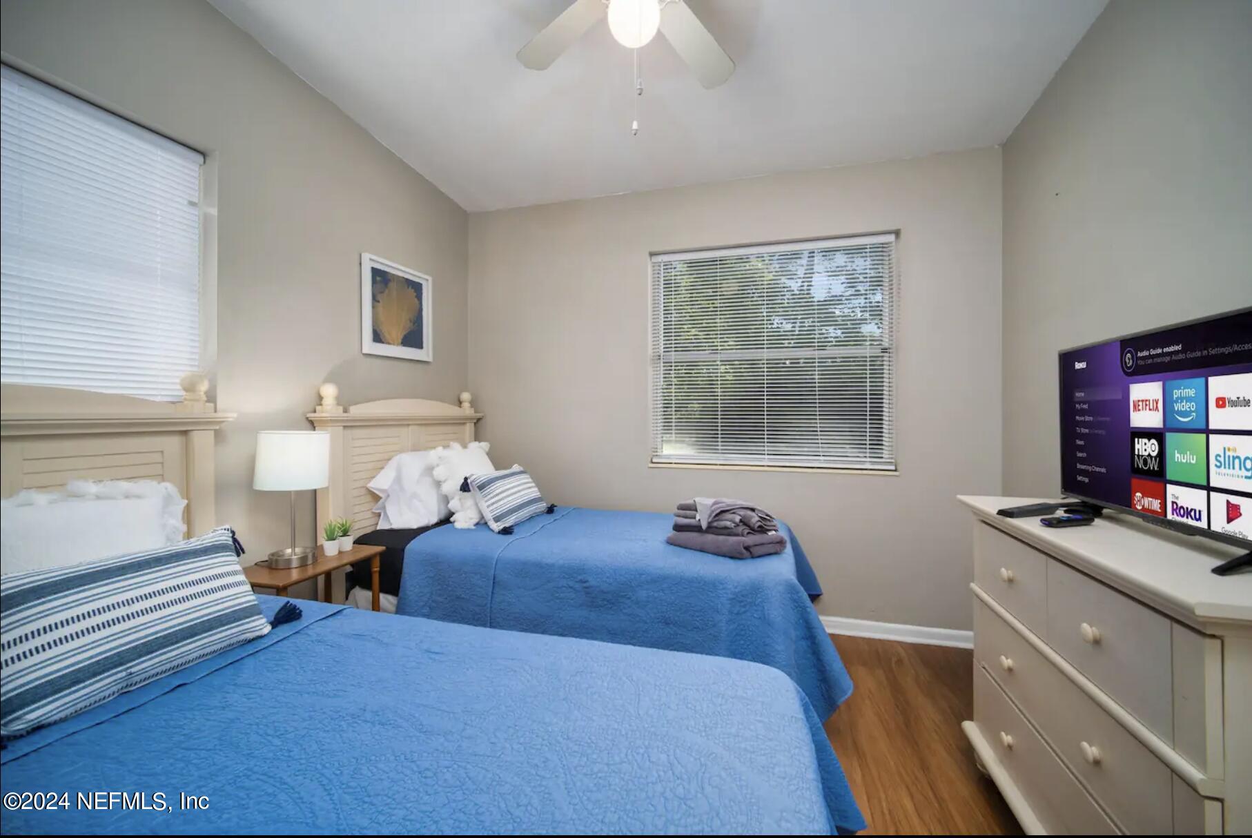 7466 Proxima Road Jacksonville, FL 32210 - Photo 23 of 34 a bedroom with a bed and wooden floor