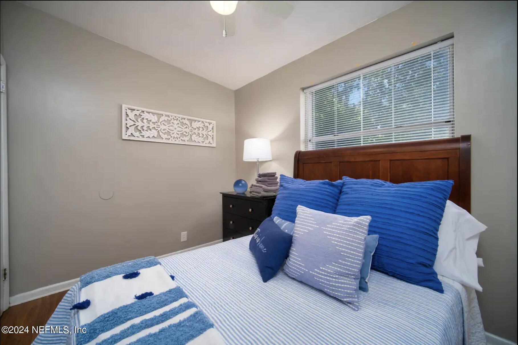 7466 Proxima Road Jacksonville, FL 32210 - Photo 25 of 34 a bed sitting in a bedroom next to a window