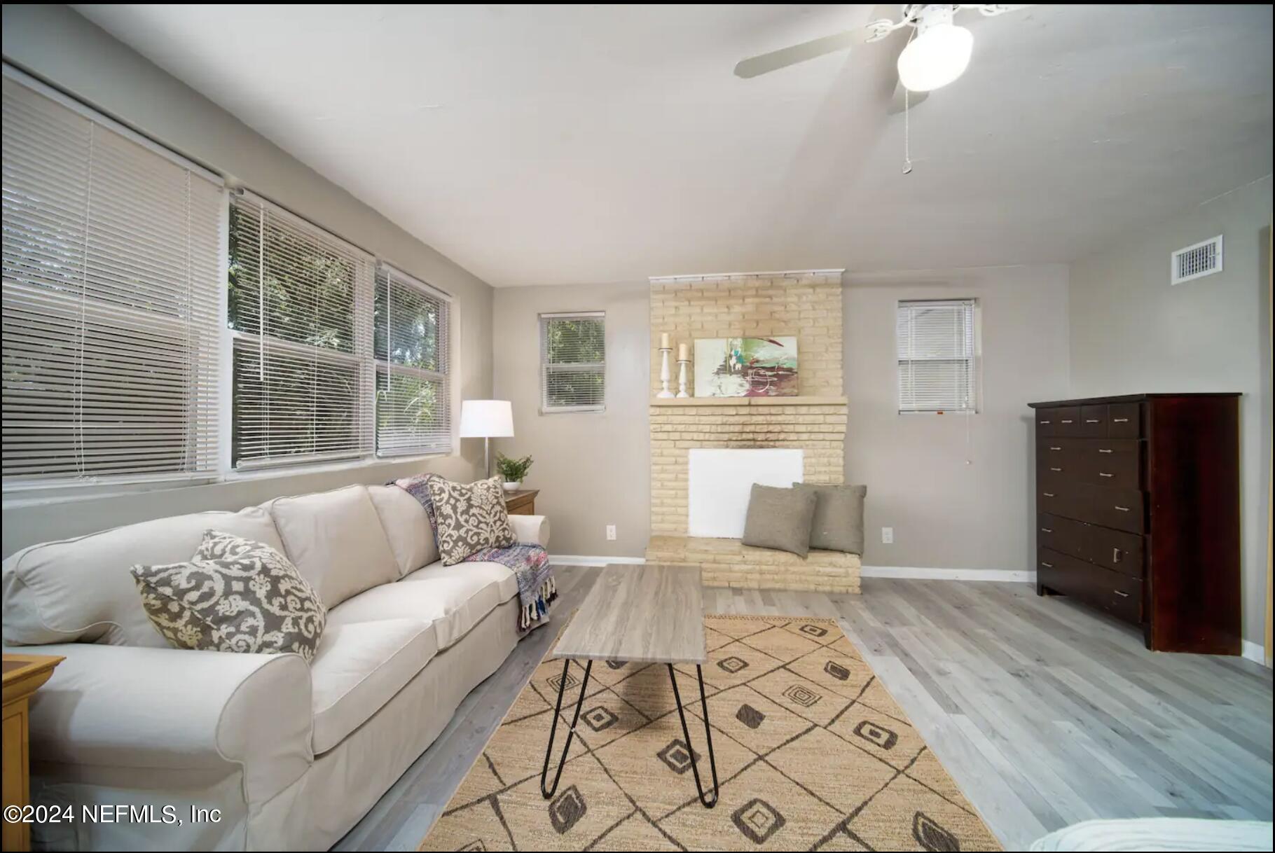 7466 Proxima Road Jacksonville, FL 32210 - Photo 5 of 34 a living room with furniture and a window