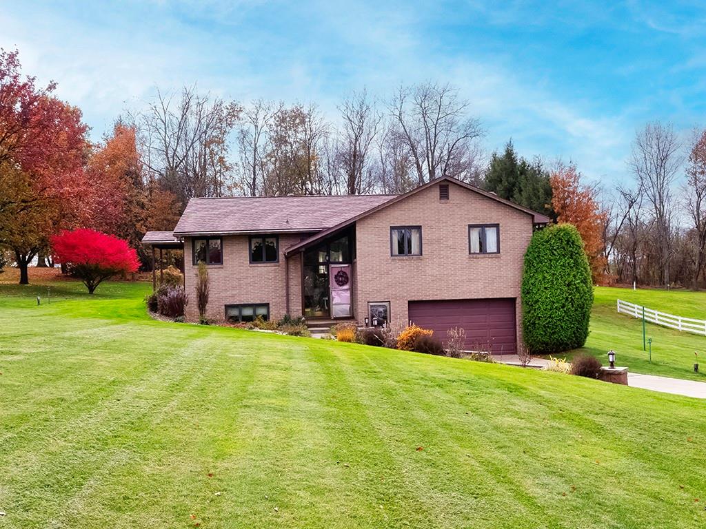 a view of a house with a yard and sitting area