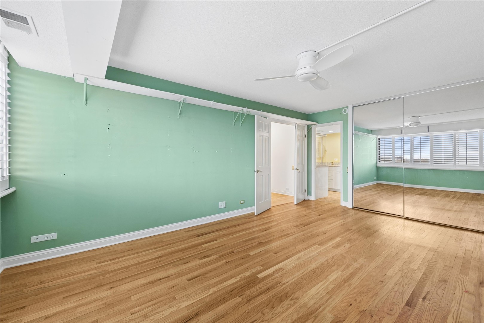 2 South Atrium Way, Unit 603 Elmhurst, IL 60126 - Photo 11 of 16 a view of empty room with wooden floor and fan