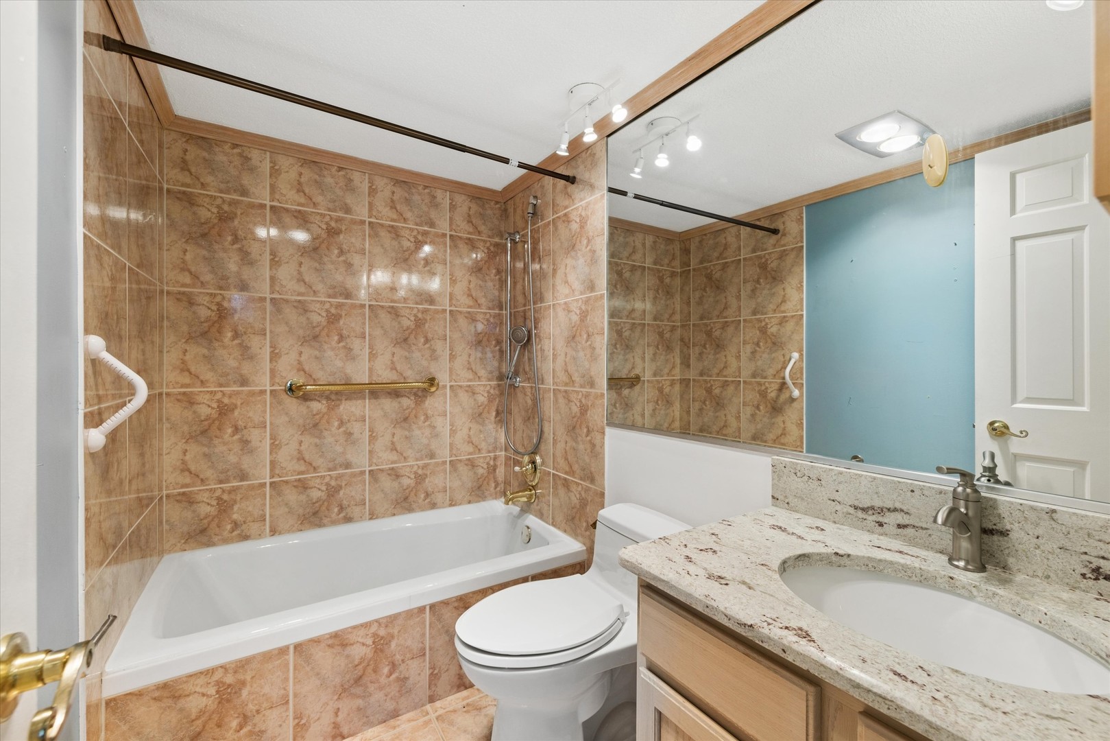 2 South Atrium Way, Unit 603 Elmhurst, IL 60126 - Photo 12 of 16 a bathroom with a granite countertop bathtub shower sink vanity and toilet
