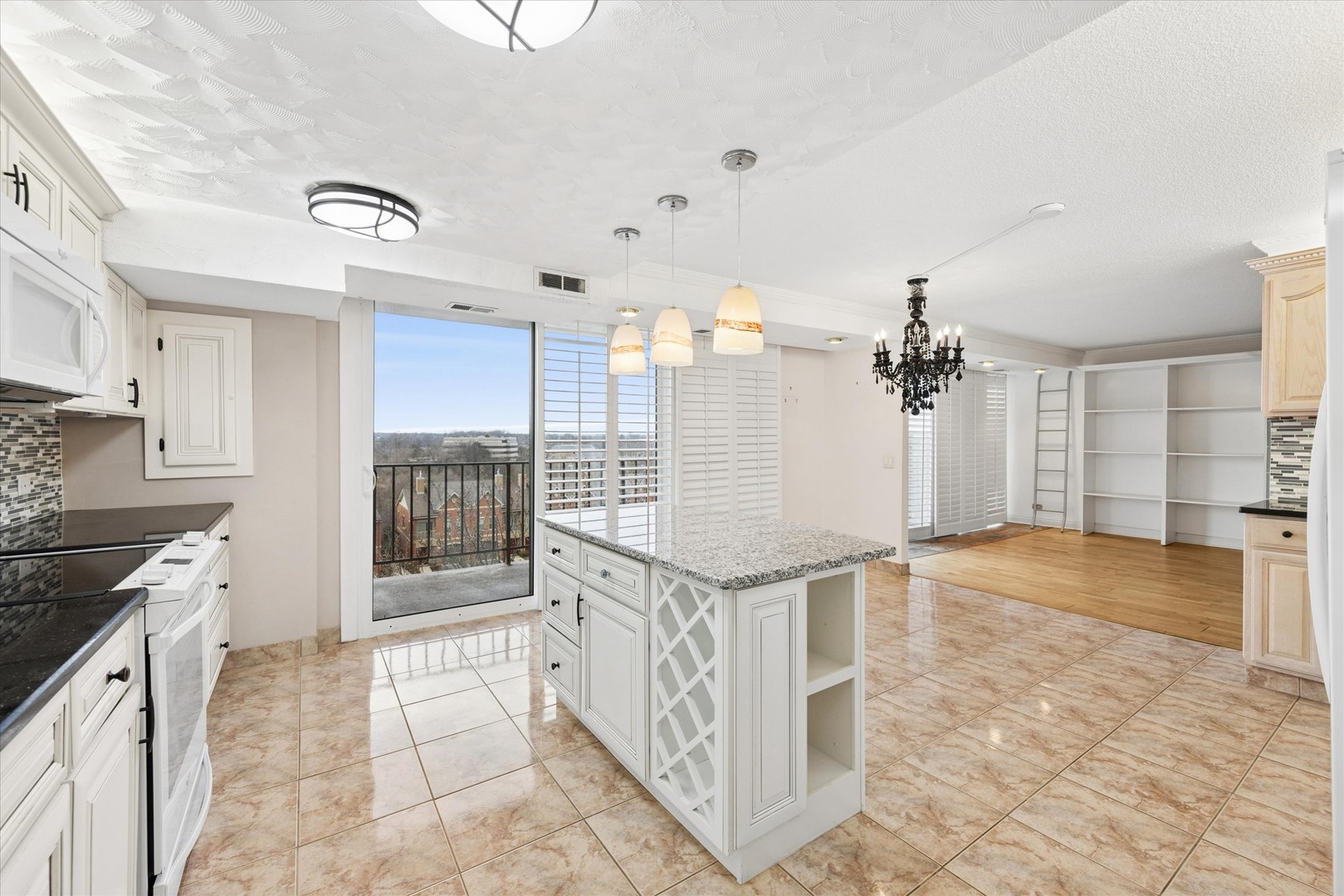 2 South Atrium Way, Unit 603 Elmhurst, IL 60126 - Photo 2 of 16 a open kitchen with kitchen island granite countertop a stove a sink and a refrigerator
