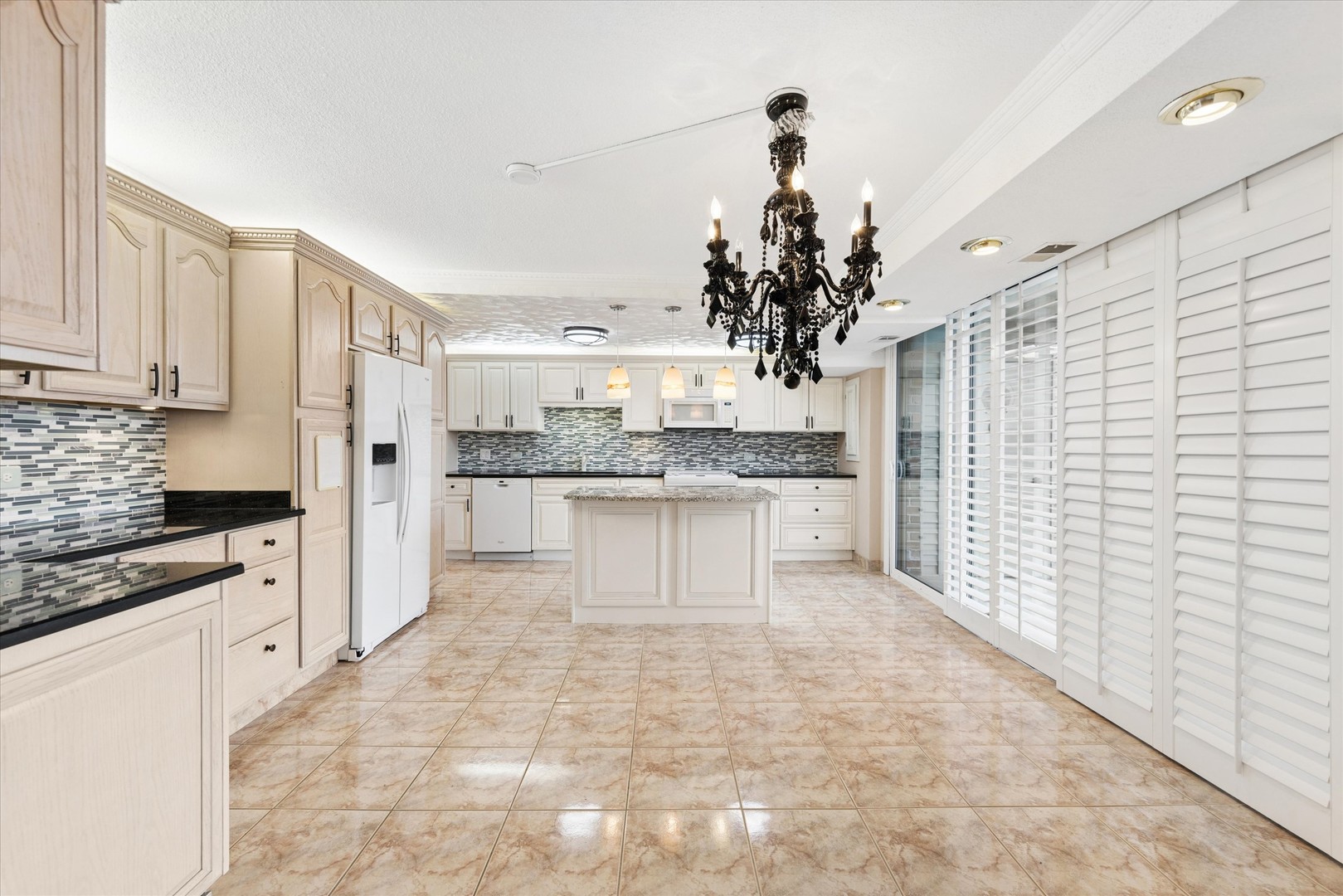 2 South Atrium Way, Unit 603 Elmhurst, IL 60126 - Photo 3 of 16 a large white kitchen with granite countertop a stove a sink dishwasher and white cabinets with wooden floor