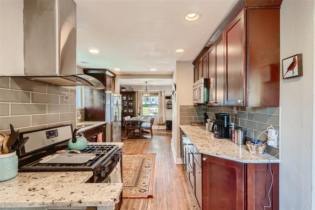 4140 Decatur Street Denver, CO 80211 - Photo 12 of 33 a kitchen with stainless steel appliances granite countertop a sink stove and cabinets