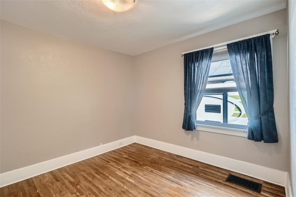 4140 Decatur Street Denver, CO 80211 - Photo 13 of 33 a view of an empty room with wooden floor and a window