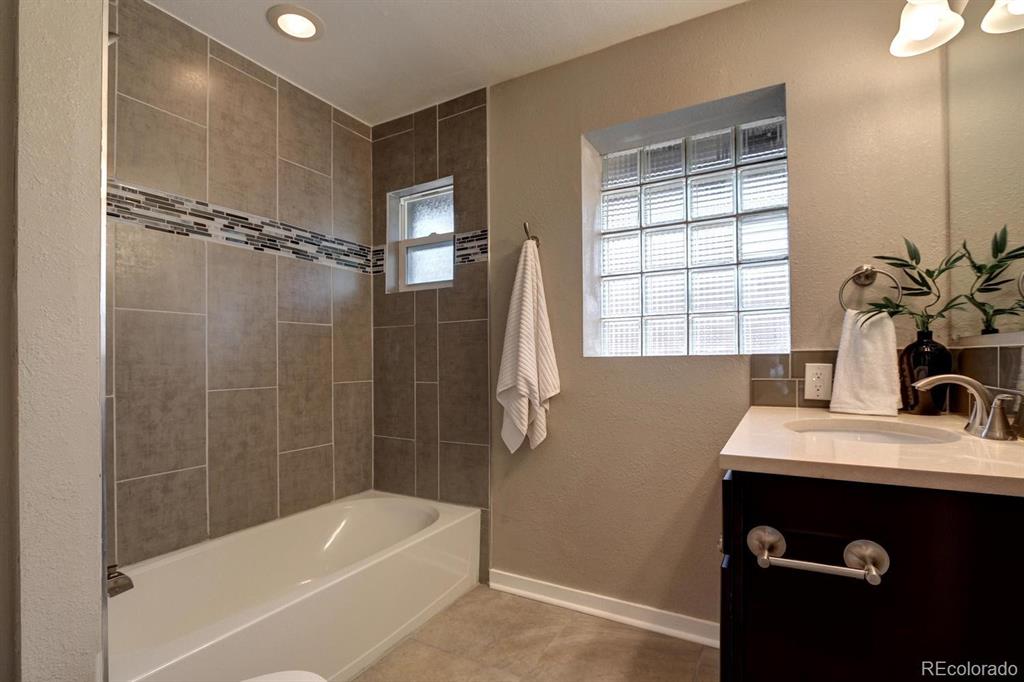 4140 Decatur Street Denver, CO 80211 - Photo 16 of 33 a bathroom with a tub sink and mirror