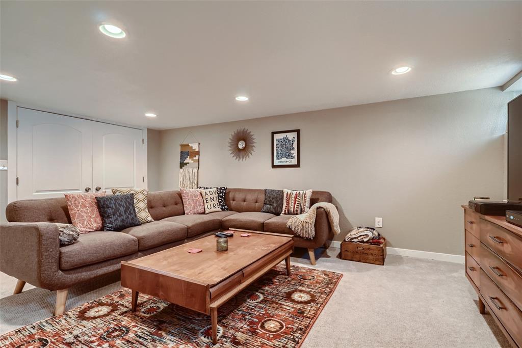 4140 Decatur Street Denver, CO 80211 - Photo 18 of 33 a living room with furniture a rug and a window