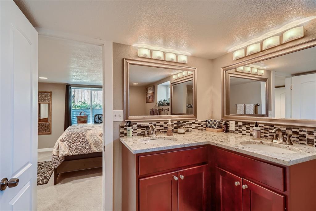 4140 Decatur Street Denver, CO 80211 - Photo 22 of 33 a en suite bathroom with a sink and a mirror