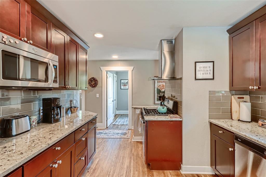 4140 Decatur Street Denver, CO 80211 - Photo 8 of 33 a kitchen with granite countertop cabinets stainless steel appliances a sink and wooden floor