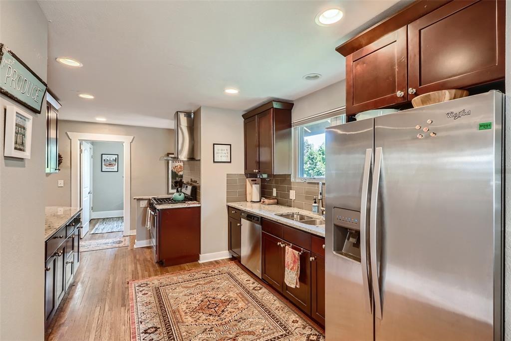 4140 Decatur Street Denver, CO 80211 - Photo 9 of 33 a kitchen with stainless steel appliances granite countertop a refrigerator a stove and a sink