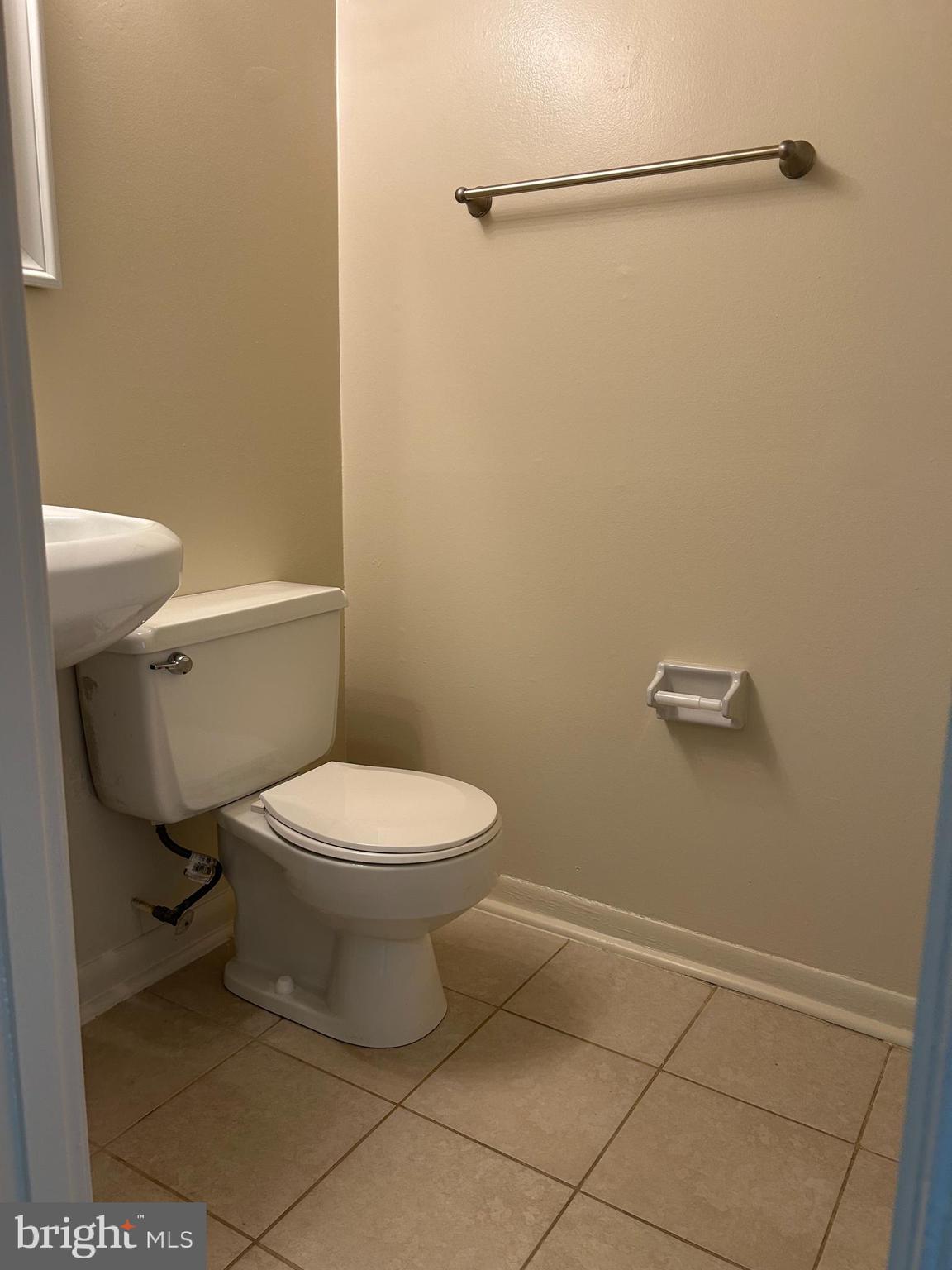 1600 Ruxton Road, Unit B4 Baltimore, MD 21204 - Photo 11 of 21 a white toilet sitting next to a bathroom sink