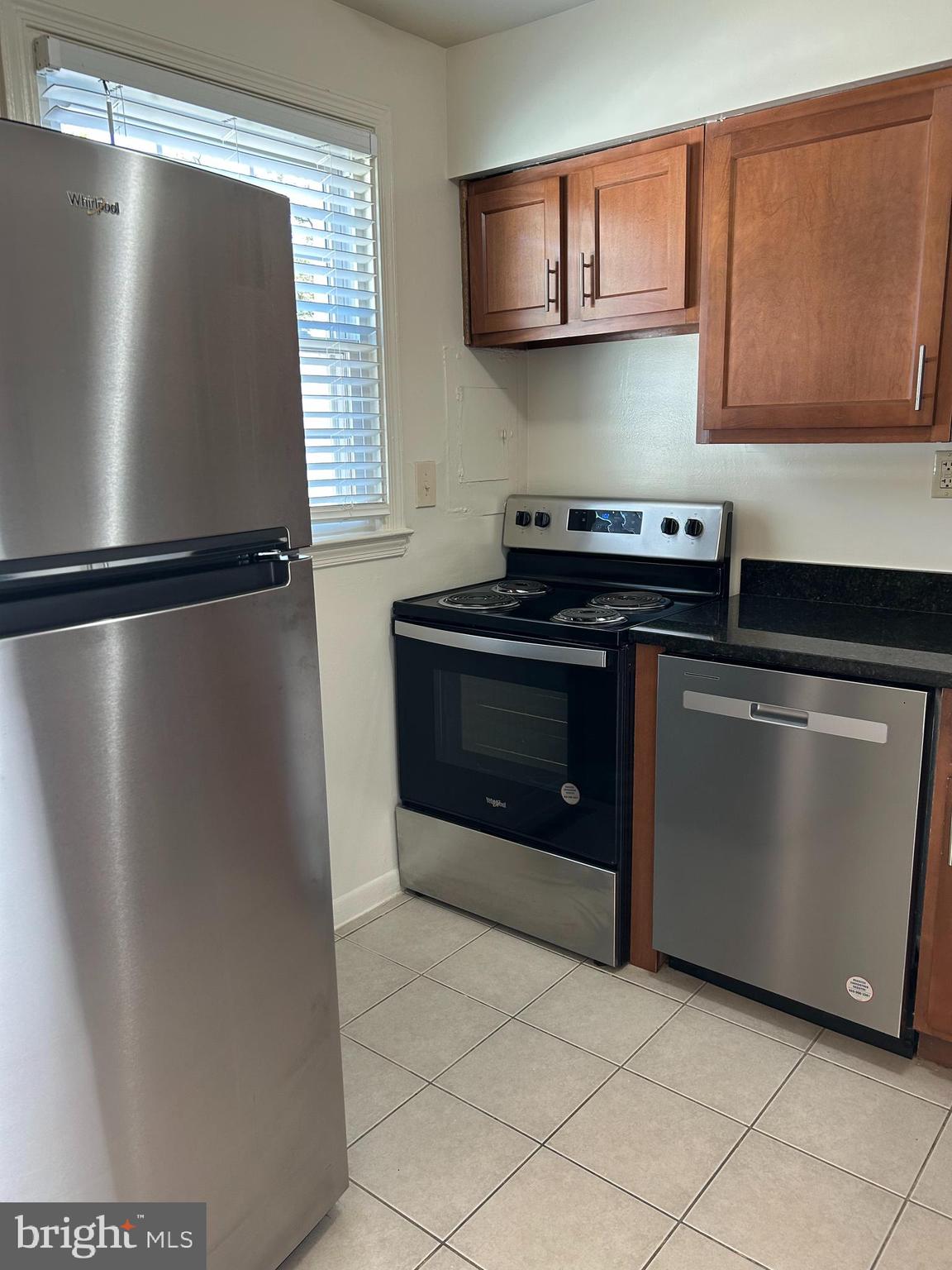 1600 Ruxton Road, Unit B4 Baltimore, MD 21204 - Photo 7 of 21 a kitchen with stainless steel appliances granite countertop a refrigerator a stove and a sink