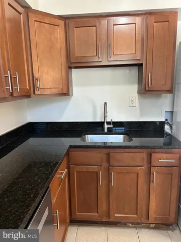 a kitchen with granite countertop cabinets and sink