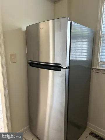 a white refrigerator freezer sitting inside of a kitchen