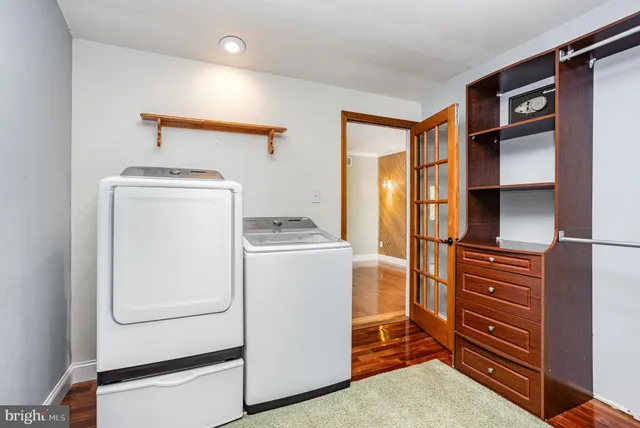 a living room with furniture cabinets and a window
