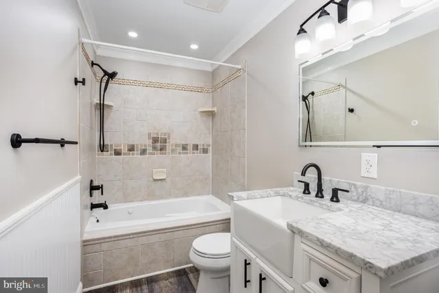 a view of a livingroom with wooden floor and ceiling fan