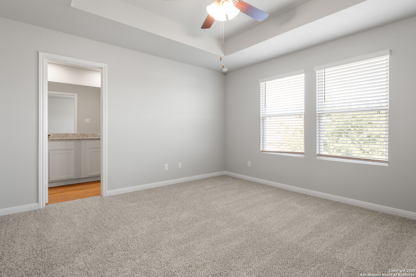 3924 Abbott Pass, Unit 101 St. Hedwig, TX 78152 - Photo 13 of 17 an empty room with chandelier fan and windows