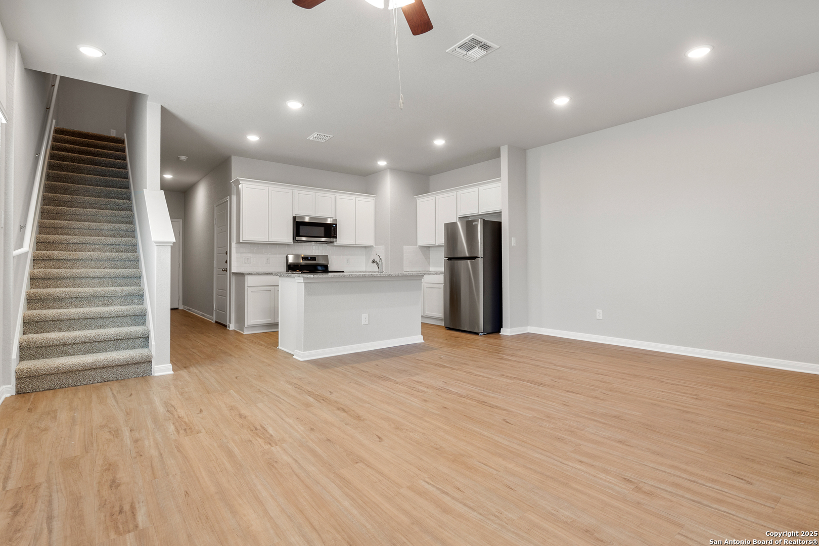 3924 Abbott Pass, Unit 101 St. Hedwig, TX 78152 - Photo 3 of 17 a view of a kitchen with a sink and a refrigerator