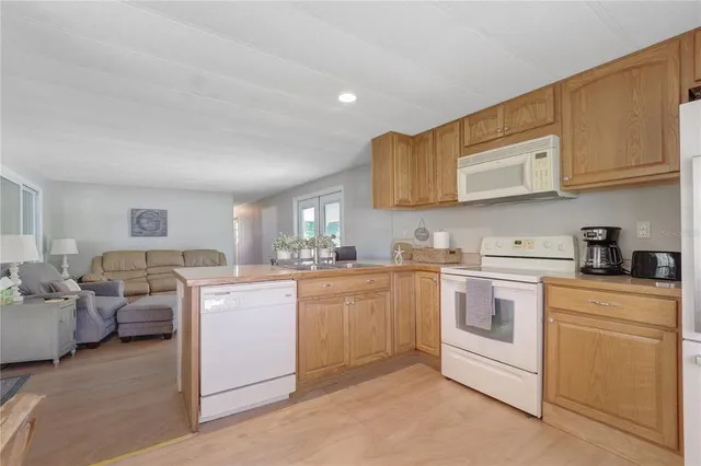 a kitchen with cabinets and window