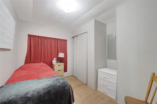 a bedroom with a bed and a closet