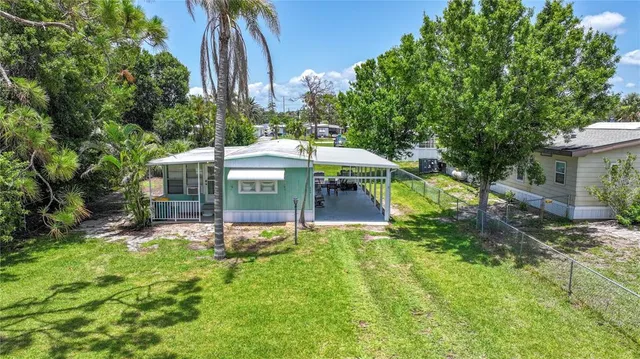 a view of a house with a yard and sitting area