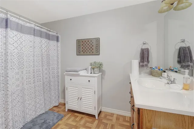 a bathroom with a sink a mirror and shower