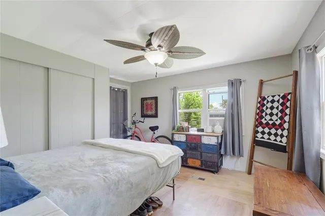 a bedroom with a bed a dresser and a window