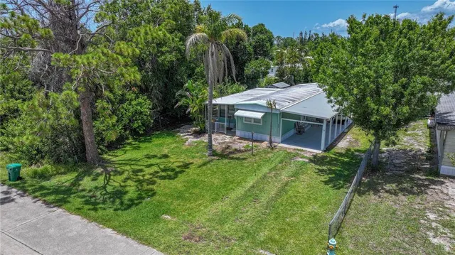 a view of a house with a backyard and a patio