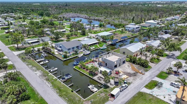 an aerial view of lake and residential houses with outdoor space