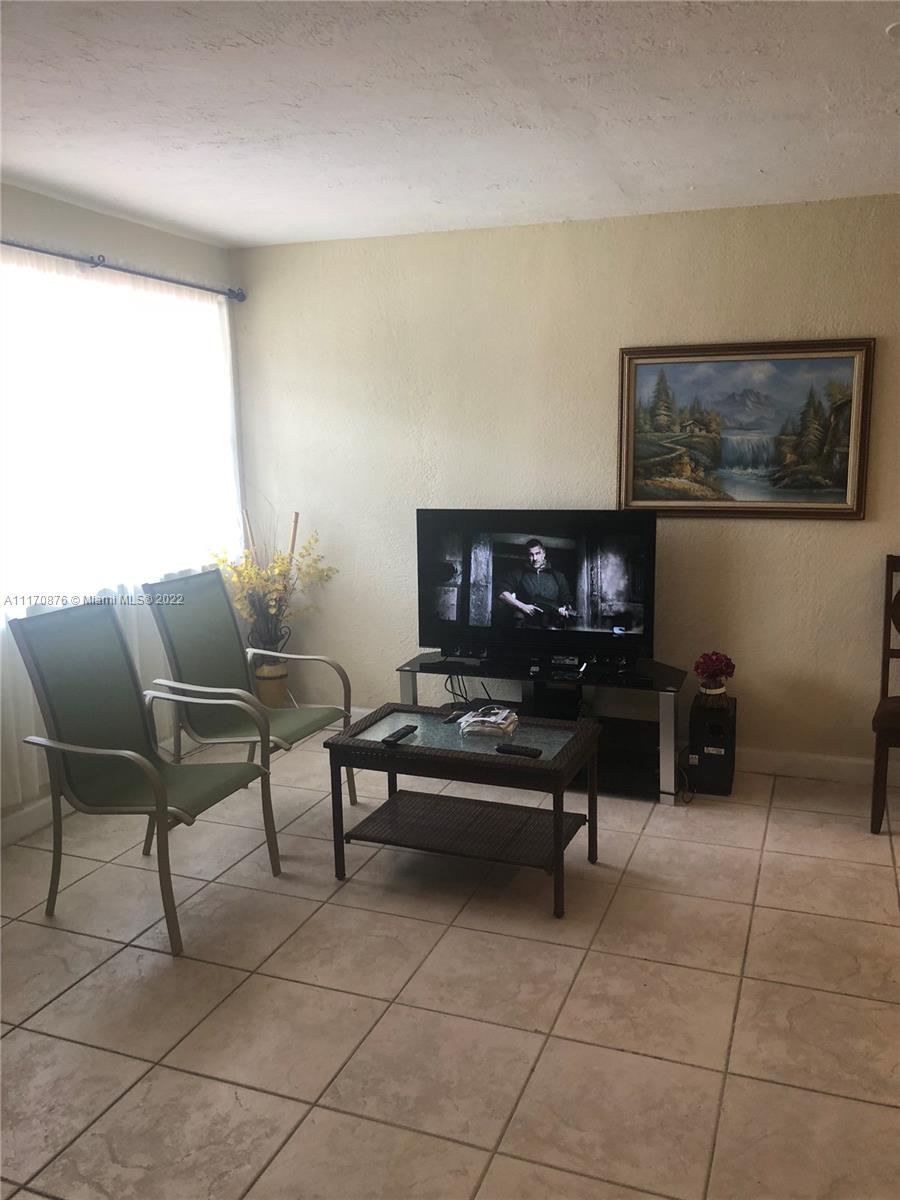4001 Northwest 3rd Street Miami, FL 33126 - Photo 11 of 17 a living room with furniture and a potted plant
